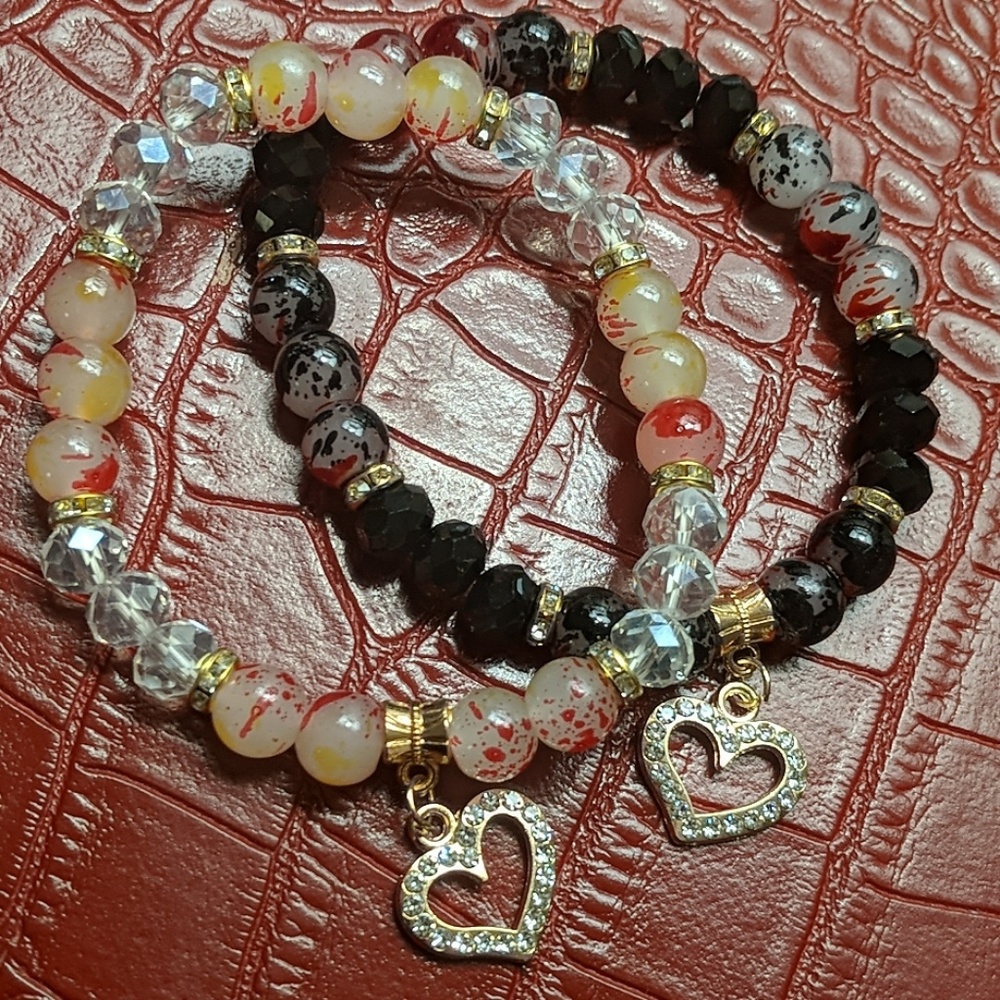 Two beaded bracelets with charms